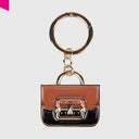 CROMIA CHARM IT BAG Taschenanhänger in Mini-Handtaschenform mit glänzender Oberfläche, goldfarbenen Details und Schlüsselring